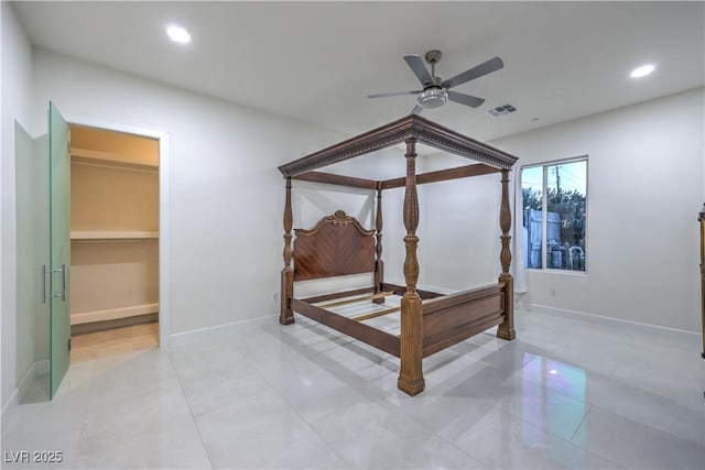 bedroom featuring ceiling fan and a walk in closet