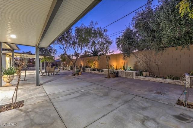 view of patio terrace at dusk