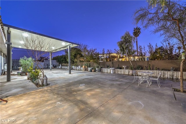 view of patio terrace at dusk