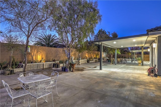 view of patio terrace at dusk