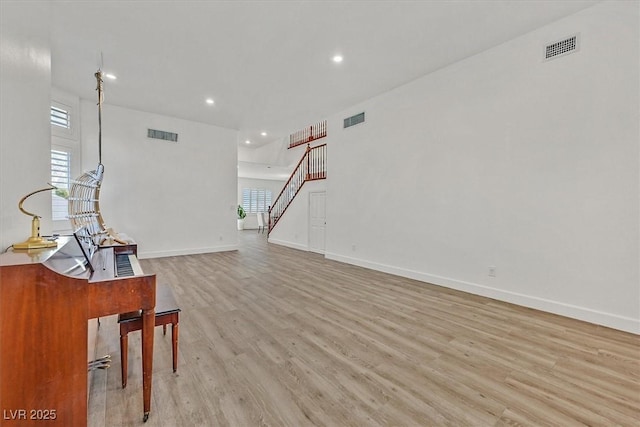 living room with a healthy amount of sunlight and light hardwood / wood-style floors