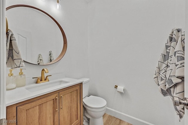 bathroom with vanity, toilet, and wood-type flooring