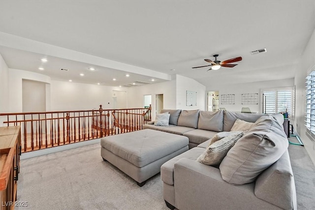 carpeted living room with ceiling fan