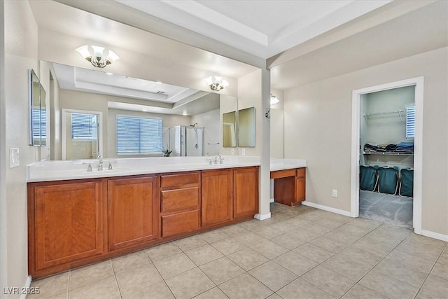 bathroom featuring tile patterned flooring, vanity, and a tray ceiling