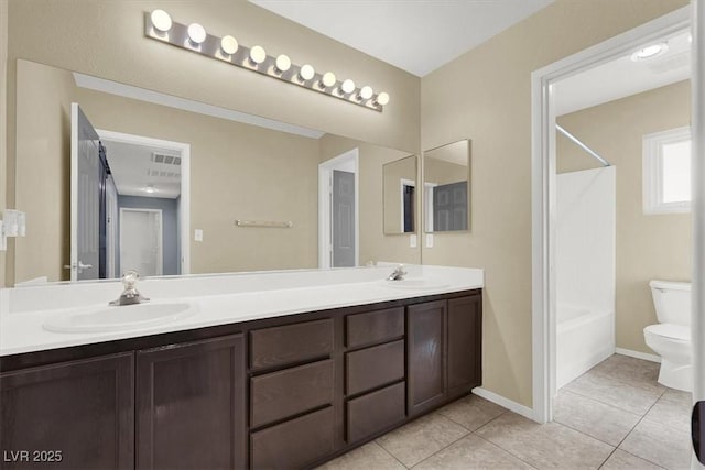 full bathroom featuring tile patterned flooring, vanity, shower / washtub combination, and toilet