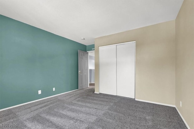 unfurnished bedroom with a closet and carpet flooring