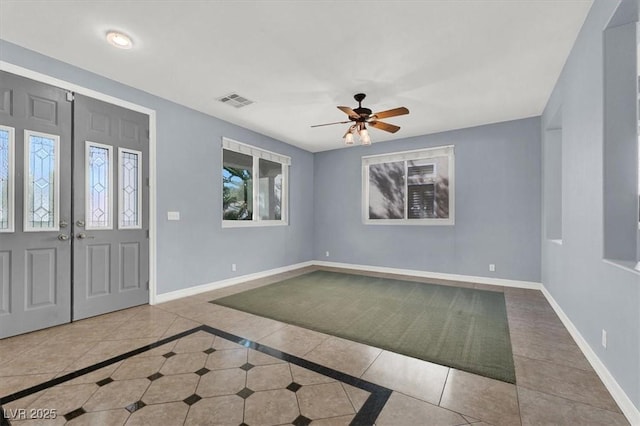 tiled entryway featuring ceiling fan