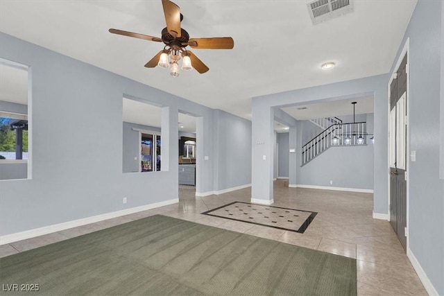 unfurnished living room with light tile patterned flooring and ceiling fan