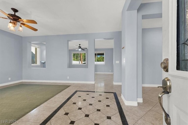 tiled foyer featuring ceiling fan