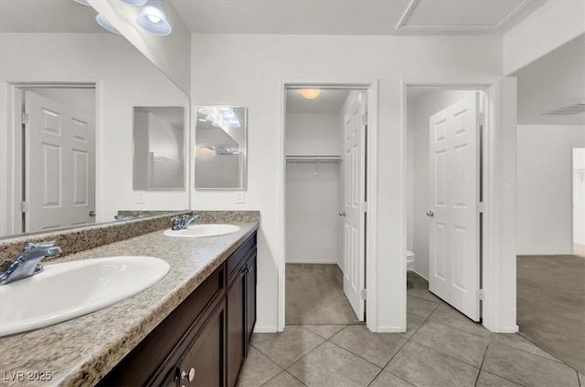 bathroom with tile patterned flooring, vanity, and toilet