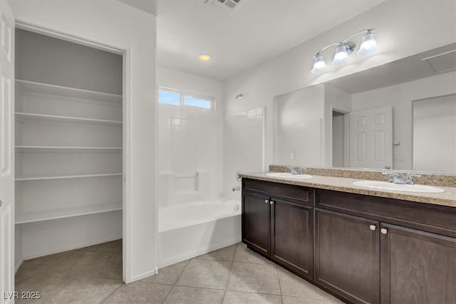 bathroom with tile patterned flooring, vanity, and tub / shower combination