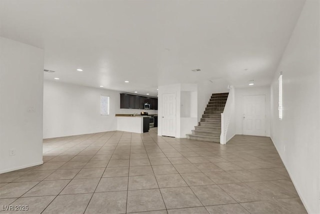 unfurnished living room with light tile patterned flooring