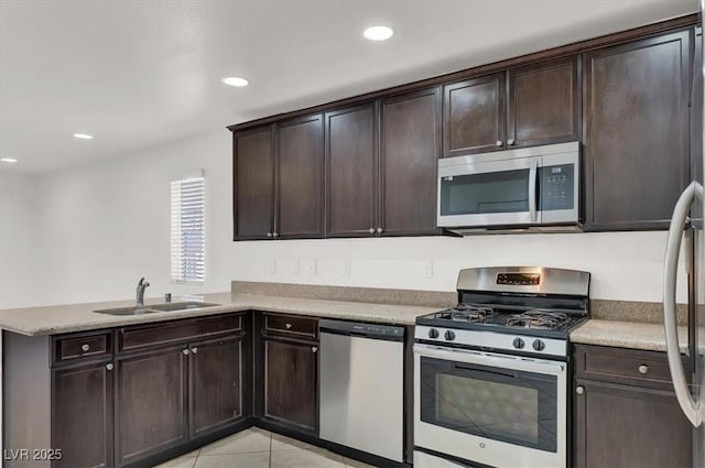 kitchen with sink, dark brown cabinets, kitchen peninsula, and appliances with stainless steel finishes