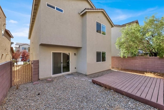 rear view of property featuring a deck