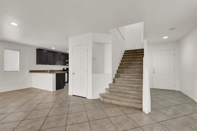 stairway featuring sink and tile patterned flooring