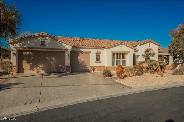 mediterranean / spanish home with a garage