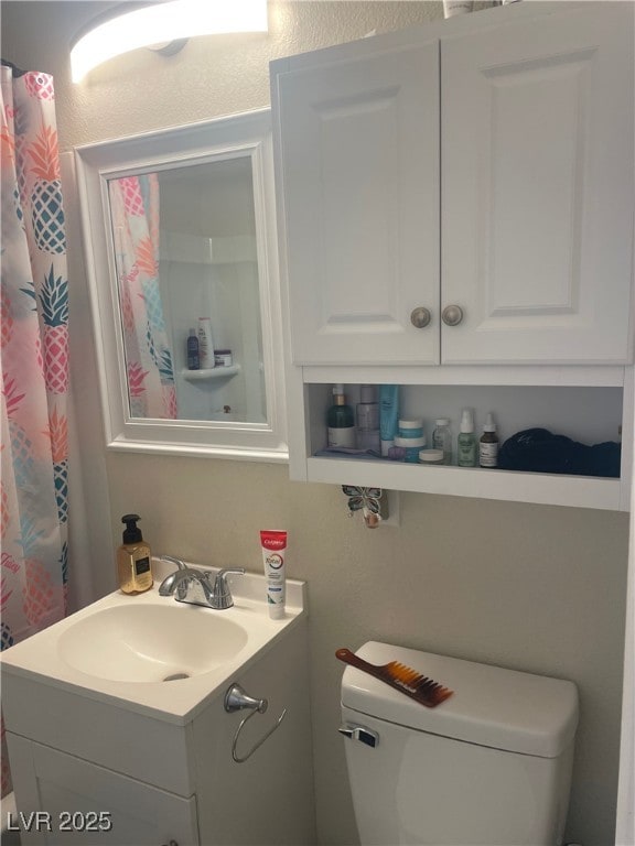 bathroom featuring vanity and toilet