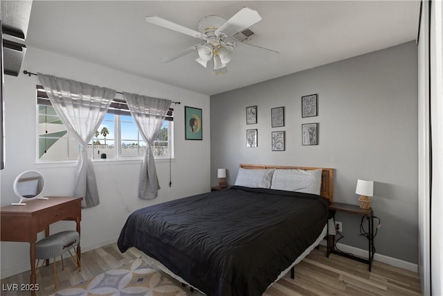 bedroom with ceiling fan and light wood-type flooring