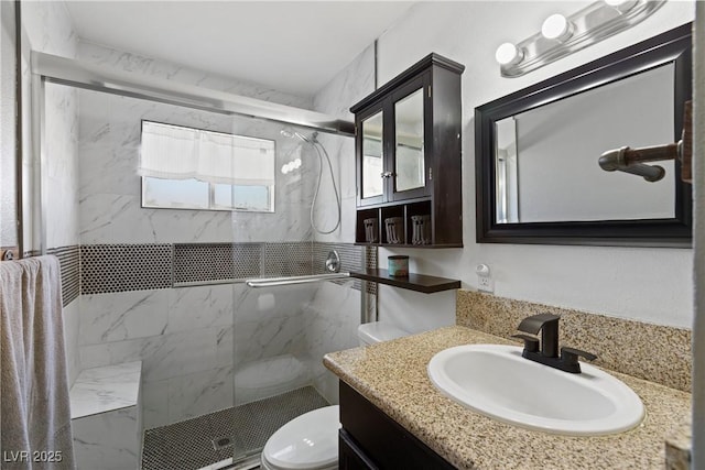 bathroom featuring an enclosed shower, vanity, and toilet