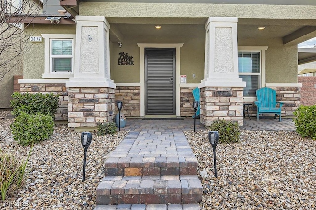 view of exterior entry with covered porch