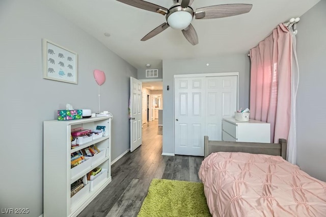 bedroom with dark hardwood / wood-style floors, ceiling fan, and a closet