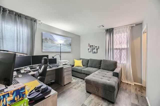 office with light hardwood / wood-style flooring