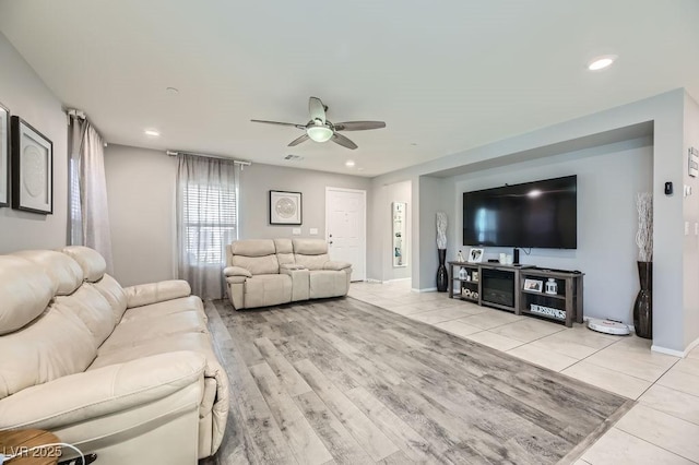 tiled living room with ceiling fan