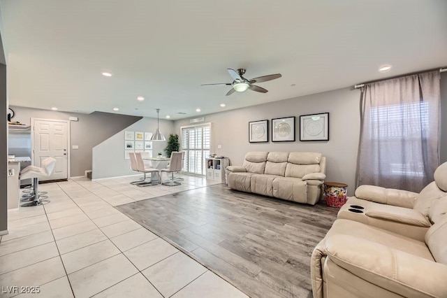 tiled living room featuring ceiling fan