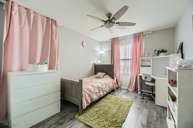 bedroom with wood-type flooring and ceiling fan