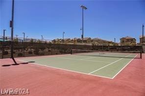 view of tennis court featuring basketball hoop