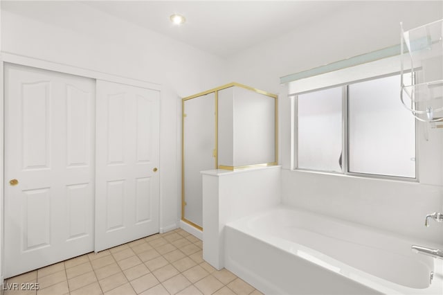 bathroom featuring tile patterned flooring and independent shower and bath