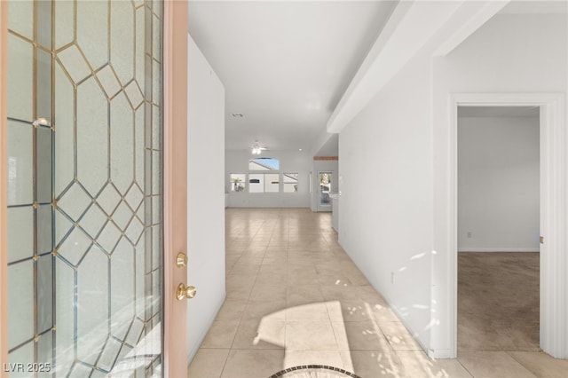 hallway with light tile patterned floors