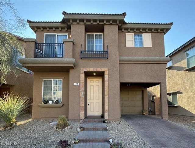 view of front of home featuring a garage and a balcony