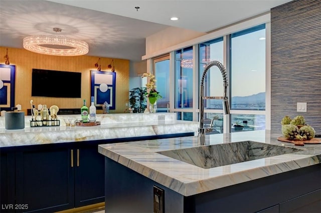 kitchen with light stone counters and sink