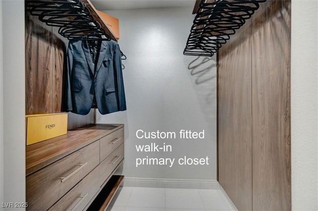 spacious closet featuring light tile patterned floors