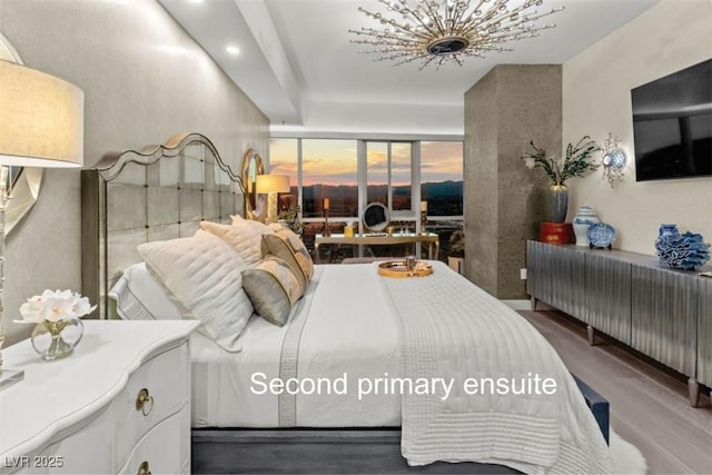 bedroom with radiator and hardwood / wood-style flooring