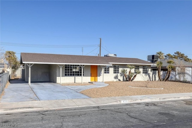 single story home featuring a carport and cooling unit