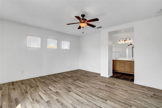 spare room with ceiling fan and light hardwood / wood-style flooring