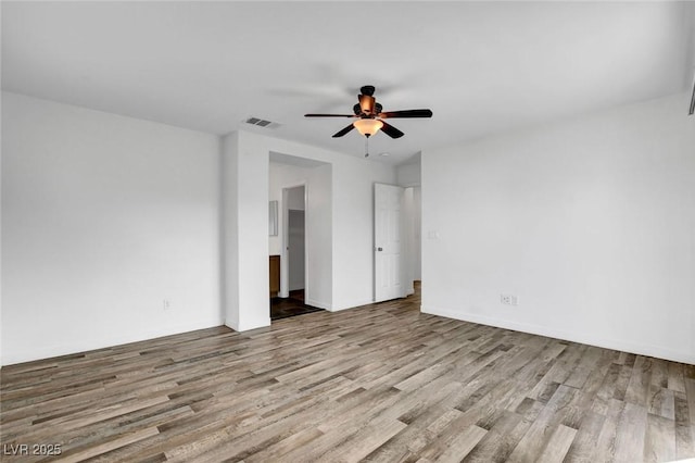 empty room with ceiling fan and light hardwood / wood-style floors