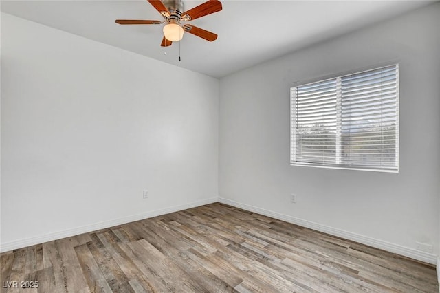 empty room with ceiling fan and light hardwood / wood-style flooring