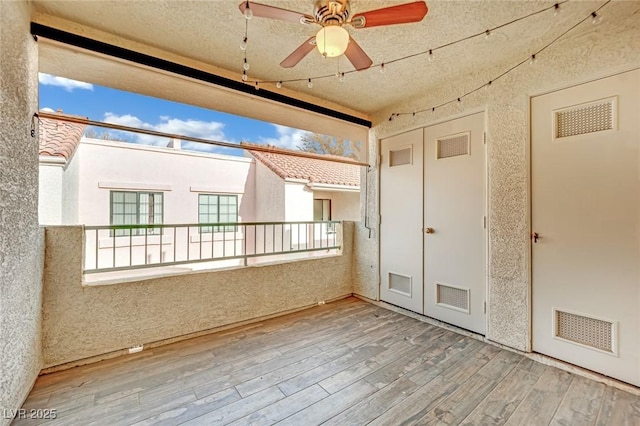 interior space with ceiling fan