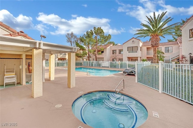 view of pool with a community hot tub and a patio area