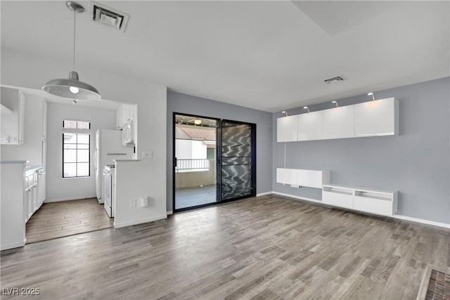 unfurnished living room featuring light hardwood / wood-style floors