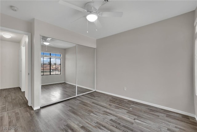 unfurnished bedroom featuring ceiling fan, hardwood / wood-style floors, and a closet