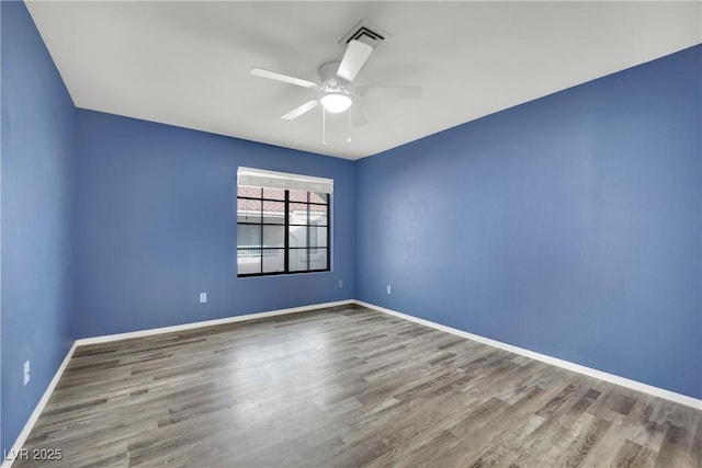 empty room featuring ceiling fan and wood-type flooring