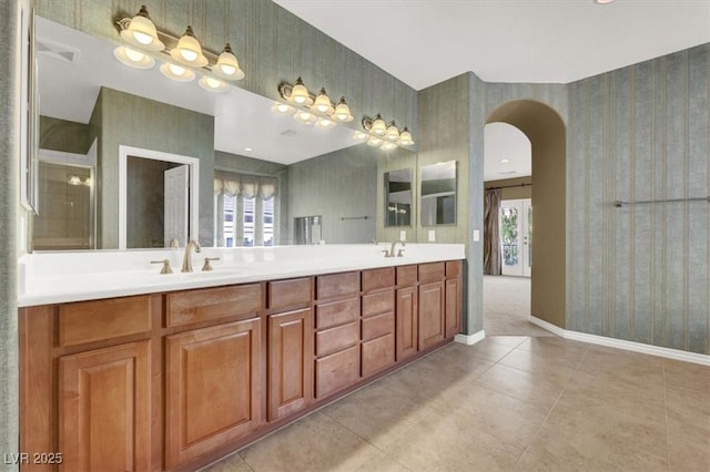 bathroom featuring vanity, a healthy amount of sunlight, and tile patterned floors