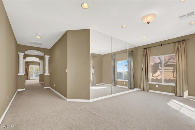 unfurnished room with light carpet and ornate columns