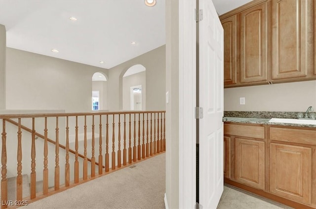 interior space with light colored carpet and sink