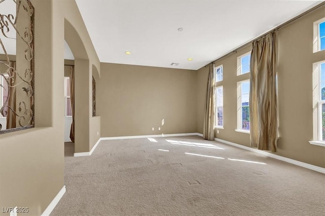 unfurnished room featuring light carpet