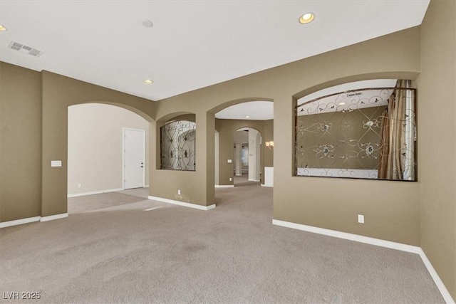 unfurnished room with light colored carpet